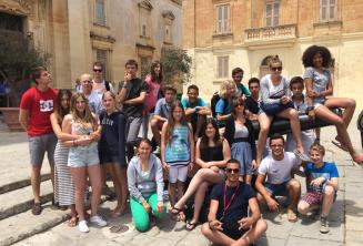 Students sitting on a canon in Mdina