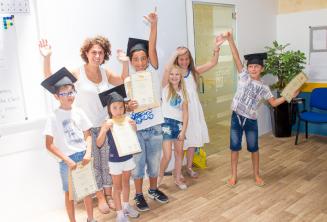 Kids with their English language course certificates