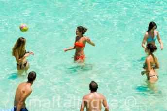 Junior school students playing volleyball at the Blue Lagoon, Malta