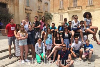 Students sitting on a canon in Mdina