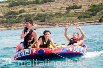 Students on a speed boat sofa ride