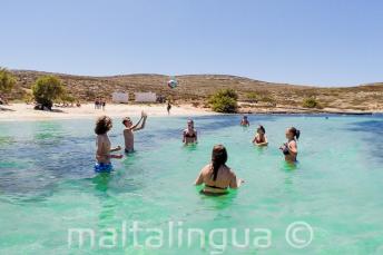 Junior students playing volleyball at the beach