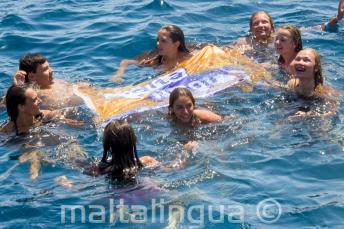 English school group leaders swimming with studetns