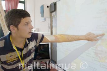 A student pointing to a map in class