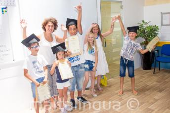 Kids with their English language course certificates