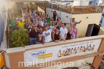 English language students waving on the school's rooftop terrace