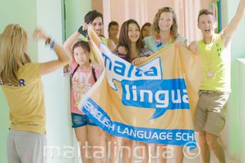 A group of students waving a flag in our summer campus