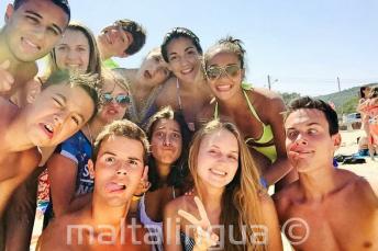 Language school students at the beach pulling funny faces