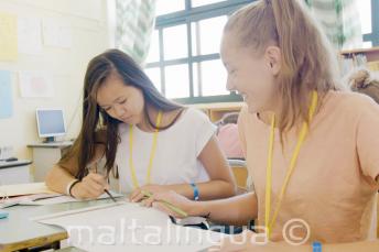 2 girls working together for an English class task