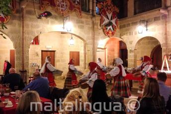 Traditional Maltese dancers putting on a show in a restaurant
