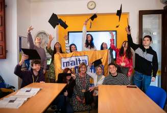 Language school students with course completion certificates