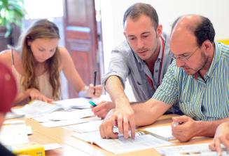 An English teacher explaining something to a student in class