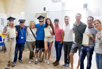 Language school students with course completion certificates