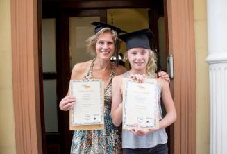 A mother and child who have both completed a language course