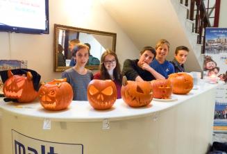 Junior students with carved Halloween pumpkins at the school reception