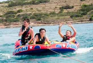 Students on a speed boat sofa ride