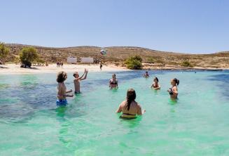 Junior students playing volleyball at the beach