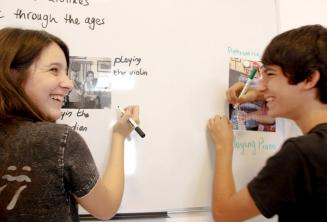 2 students working together on the class board