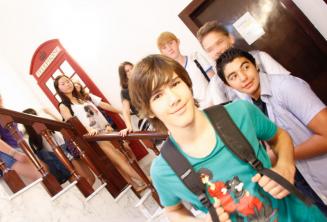 A group of students in front of a red English telephone box