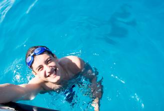 A student swimming next to the boat at Comino.