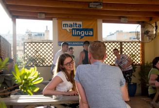 English student talking to her teacher on the terrace