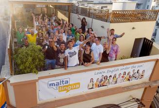 English language students waving on the school's rooftop terrace