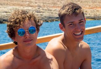 2 boys smiling on a school boat trip