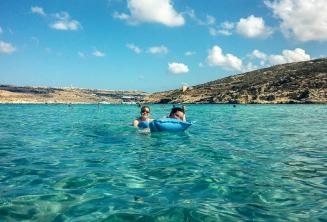 Language school students swimming in the Blue Lagoon at Comino
